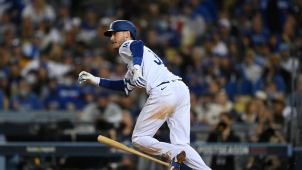 Oct 21, 2021; Los Angeles, California, USA; Los Angeles Dodgers first baseman Cody Bellinger (35) hits a single in the seventh inning against the Atlanta Braves during game five of the 2021 NLCS at Dodger Stadium. Mandatory Credit: Jayne Kamin-Oncea-USA TODAY Sports